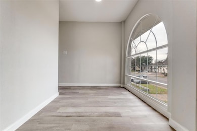 Spare room featuring baseboards and wood finished 