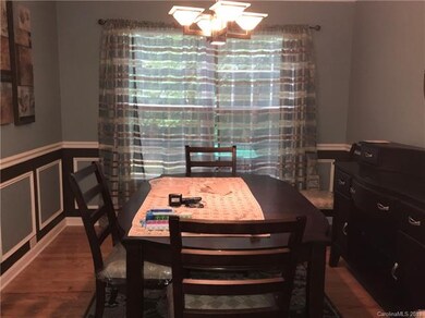 Formal Dining Room with New Pre-Finished Wood Flooring adjacent to the Kitchen and Living Room