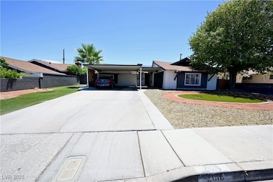 Ranch-style home with an attached carport, driveway, and brick siding