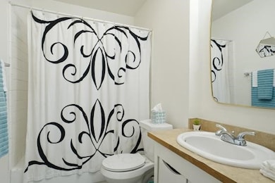 Full bath featuring vanity and shower / tub combo with curtain