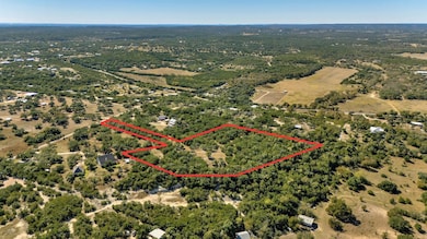 Aerial overview of property's location featuring property parcel outlined and a forest