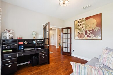 Home office with dark wood-type flooring