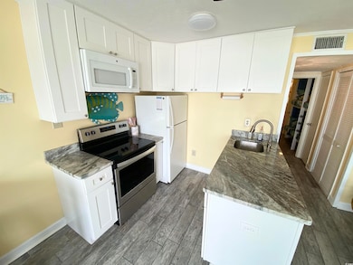 Kitchen featuring wood finished floors, baseboards