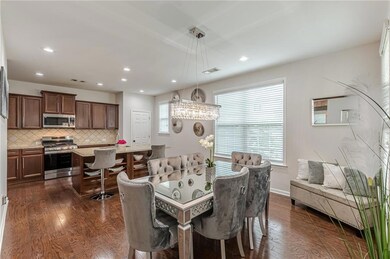 Dining space with dark wood-style floors, recessed lighting, and baseboards
