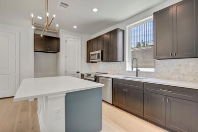 Kitchen with stainless steel appliances, a sink, 