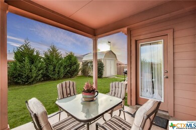 Enjoy the covered back porch.  Evergreens add priv