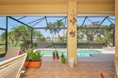 Pool featuring glass enclosure and a patio area