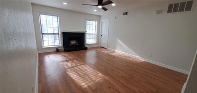 Unfurnished living room featuring ceiling fan and 