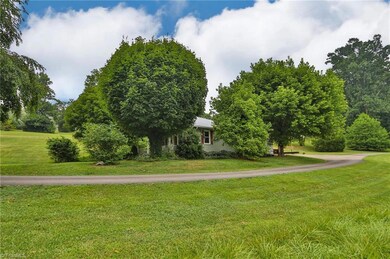 Beautiful driveway winding around to the main home