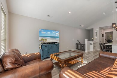 Living room with light hardwood / wood-style floor