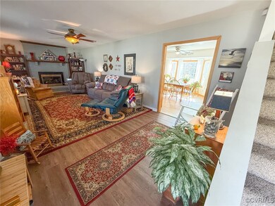 Living room featuring a glass covered fireplace, w