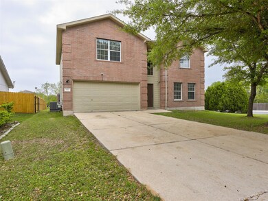 Traditional home with fence, a garage, brick sidi