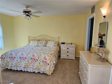 Carpeted bedroom featuring ceiling fan