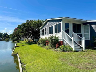View of side of property with a water view and a l