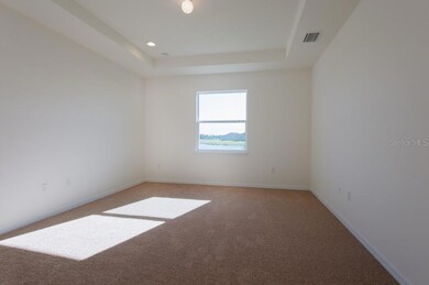 Primary bedroom has water view, door to covered lanai, 2 walk-in closets