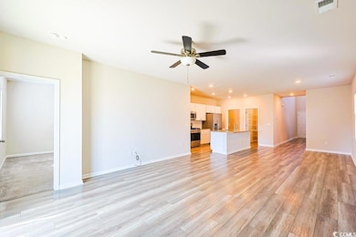 Unfurnished living room with a ceiling fan, recessed lighting, and light wood finished floors