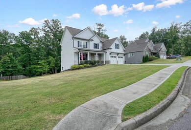 View of front of house featuring stone siding and driveway