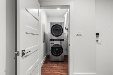 Washroom featuring stacked washing machine and dr