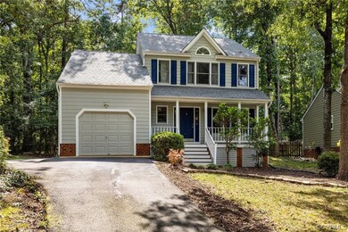View of front of house featuring garage and a porc