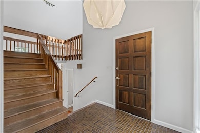 High ceilings and original details greet your visitors. Look at those tiles and wood paneled door