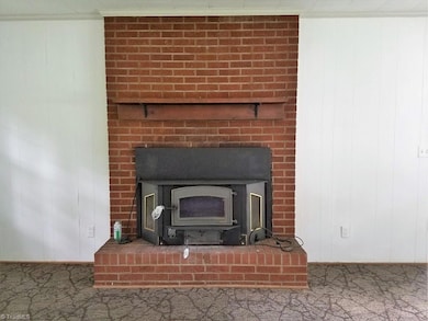 Wood burning stove with fan in Den.