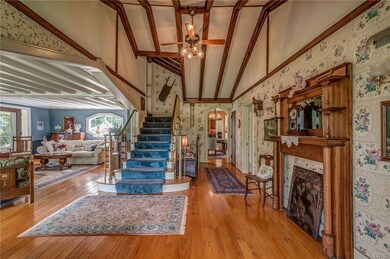Grand foyer and stairway opening up into living ro