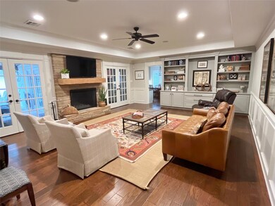 Living room featuring a fireplace, dark wood finis