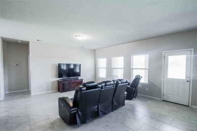 Gather the family and guests together in your lovely living room! Featuring custom paint, tile flooring, and large windows that provide plenty of natural lighting throughout the day.