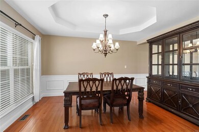 Spacious dining room with coffered ceiling and wai
