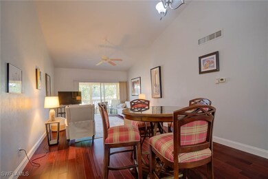 Dining room featuring visible vents, lofted ceilin