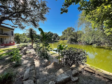 View of yard featuring a water view and view of scattered trees