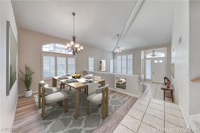 Dining room with light wood-style flooring, a chan