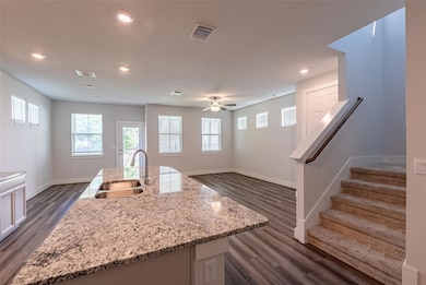 Kitchen featuring dark wood-style floors, recesse
