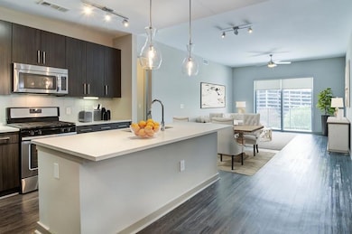 Kitchen with hanging light fixtures, dark wood-typ
