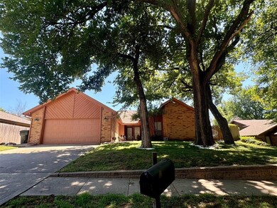 View of front of home with a front yard and a gara
