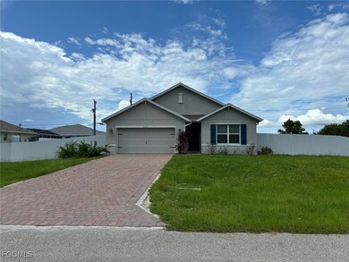 Single story home with stucco siding, decorative driveway, and an attached garage