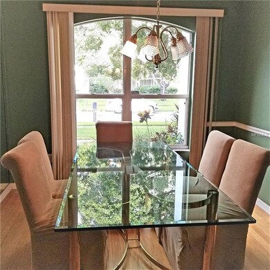 Formal dining room with hardwood floors.