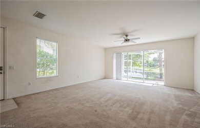Unfurnished room with healthy amount of natural light, light carpet, and ceiling fan