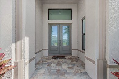 Front entry with brick pavers & double entry.