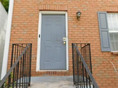 View of exterior entry with brick siding