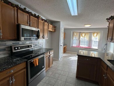 Kitchen featuring tasteful backsplash, dark stone 