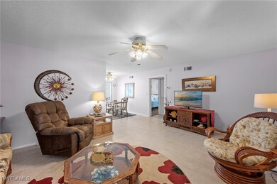 Living room with ceiling fan, light tile patterned