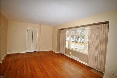 Living room has a large picture window and wood fl