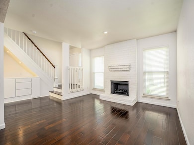 Living area with high ceilings, new energy efficient windows and a beautiful fireplace.