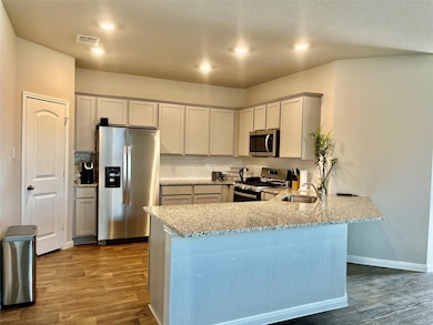 Kitchen featuring appliances with stainless steel