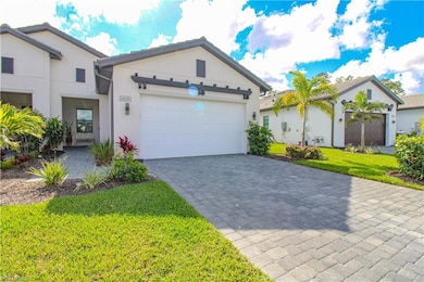 View of front of home with a front yard and a gara