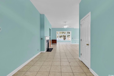 Corridor featuring light tile patterned floors and