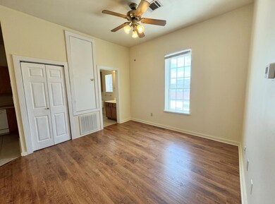 Unfurnished bedroom with wood finished floors, a 