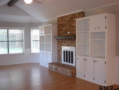 this room also has beautiful laminate wood floors, built ins, fire place and more windows w/a view