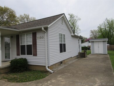 Vinyl siding and nice front porch.  Concrete drive